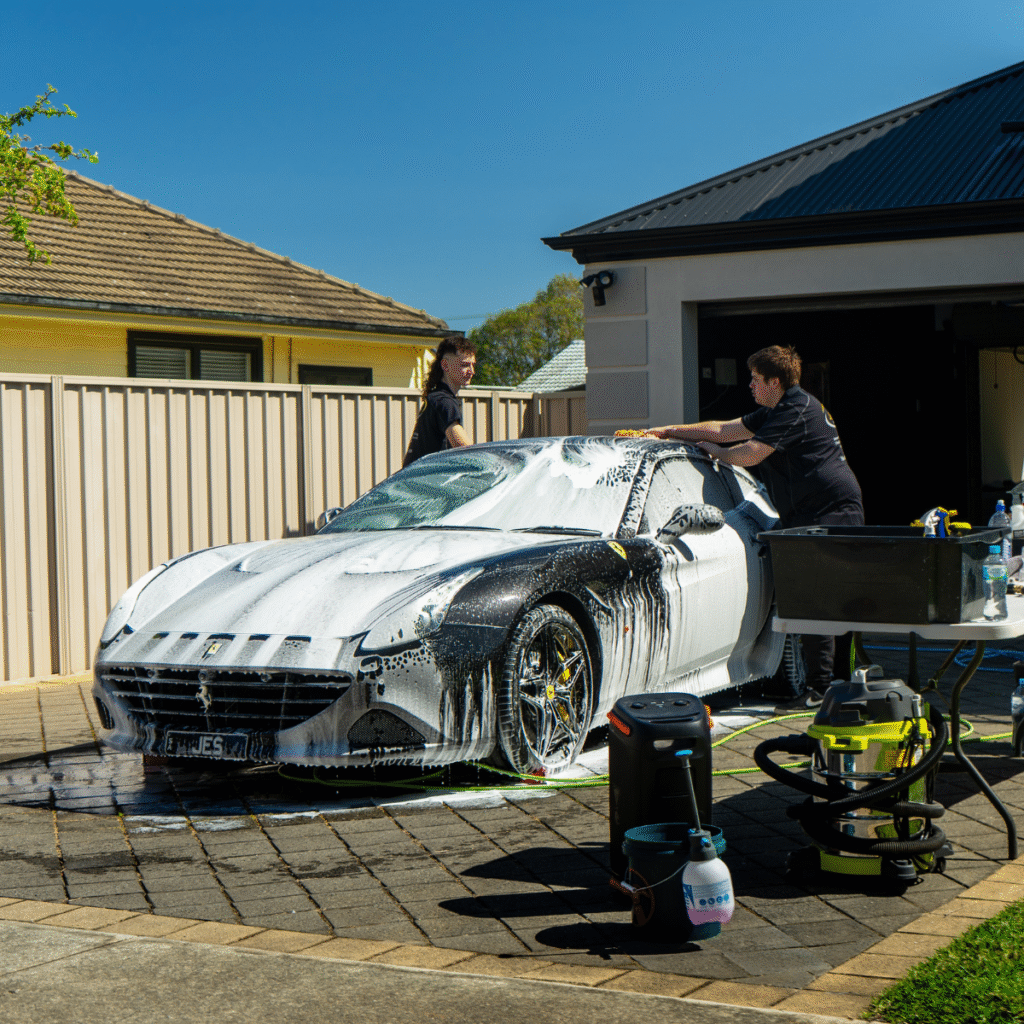 hand washing a car as part of premium exterior detailing