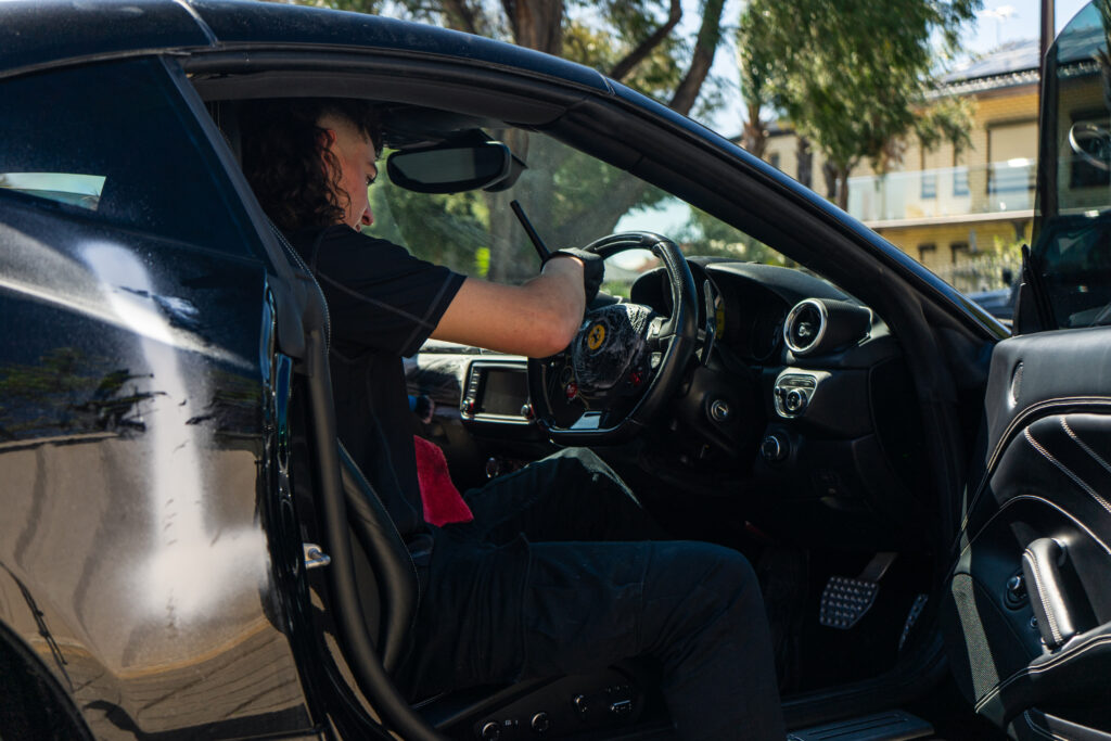Owner of Lusso Autocare doing interior car detailing