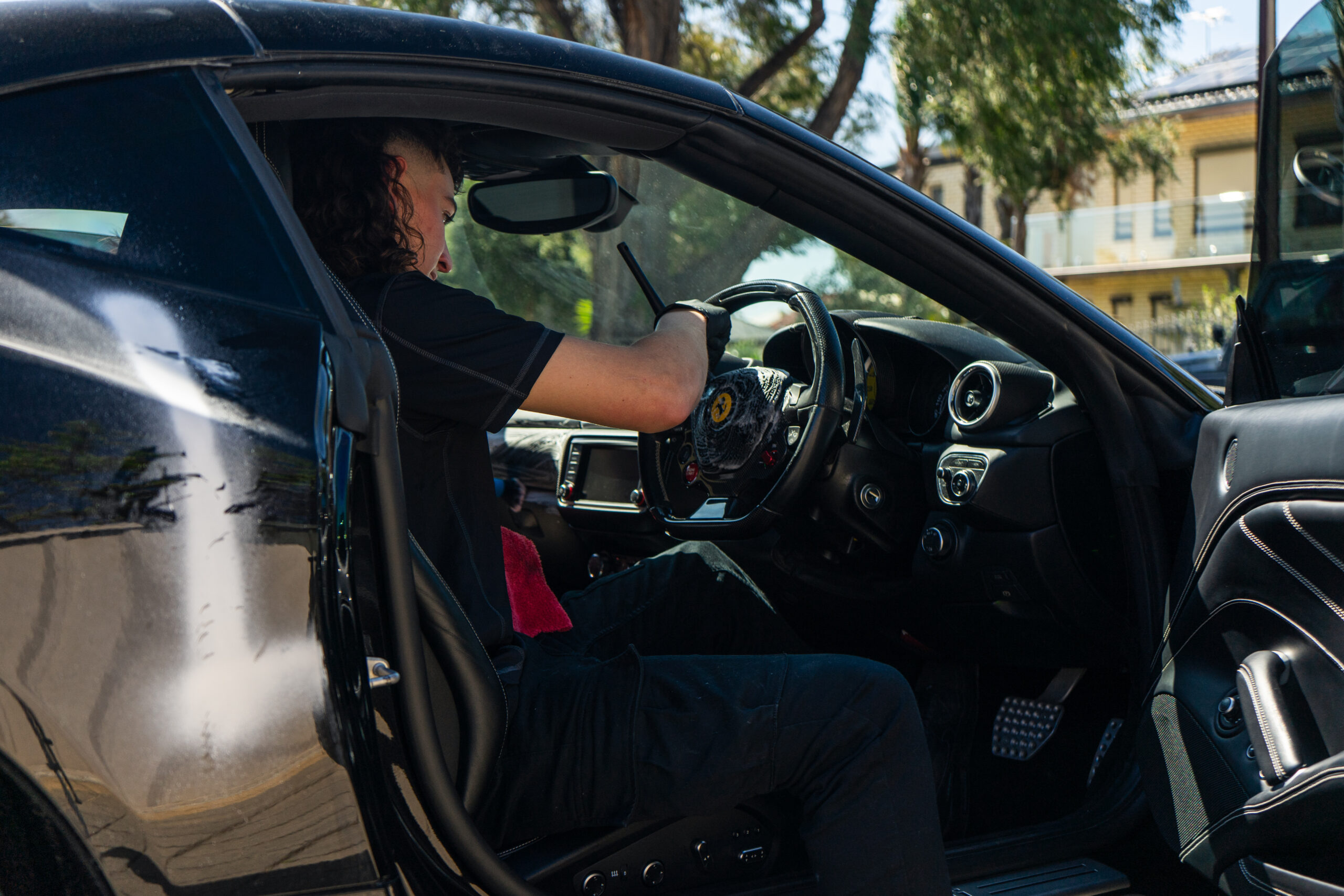 Owner of Lusso Autocare doing interior car detailing